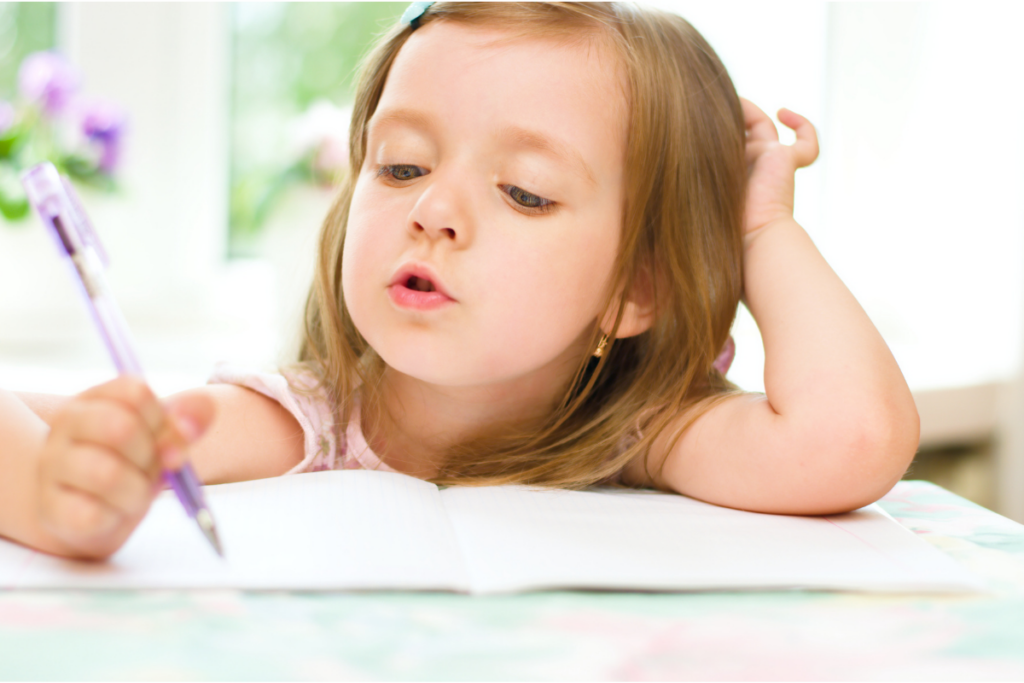 child using pen on tracing worksheets for preschoolers