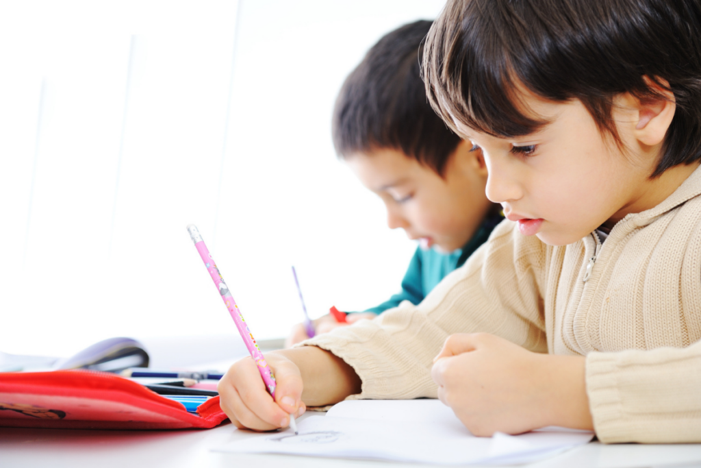 child writing on a worksheet for preschoolers numbers