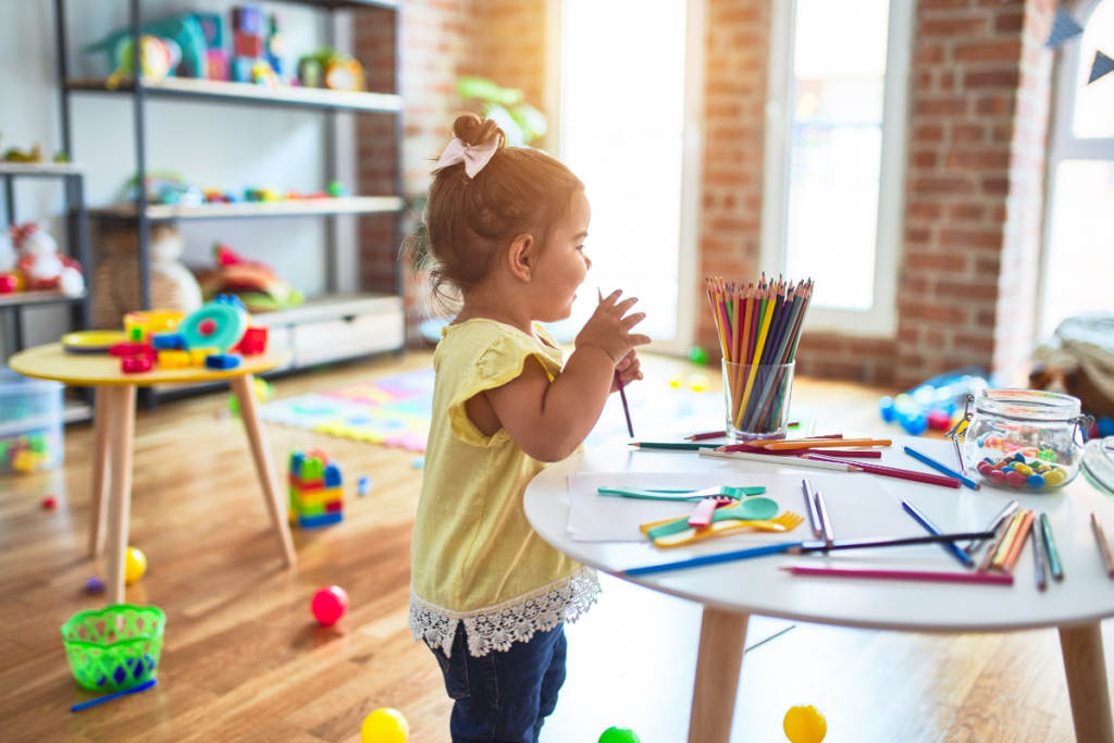 little girl doing preschool at home