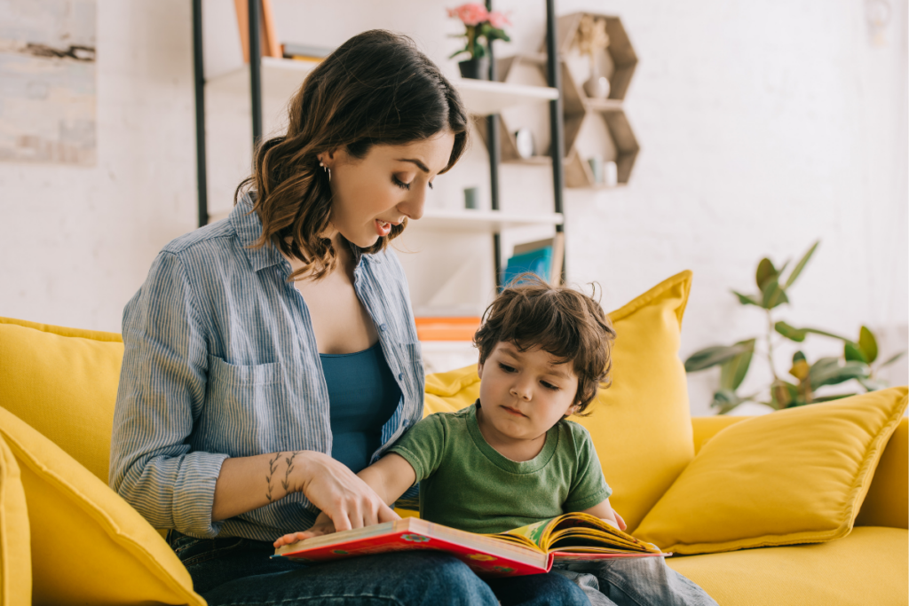 preschool child reading with mom