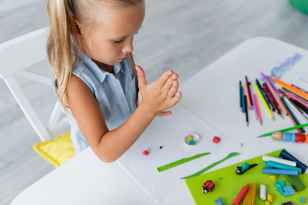 preschool child using clay or playdough